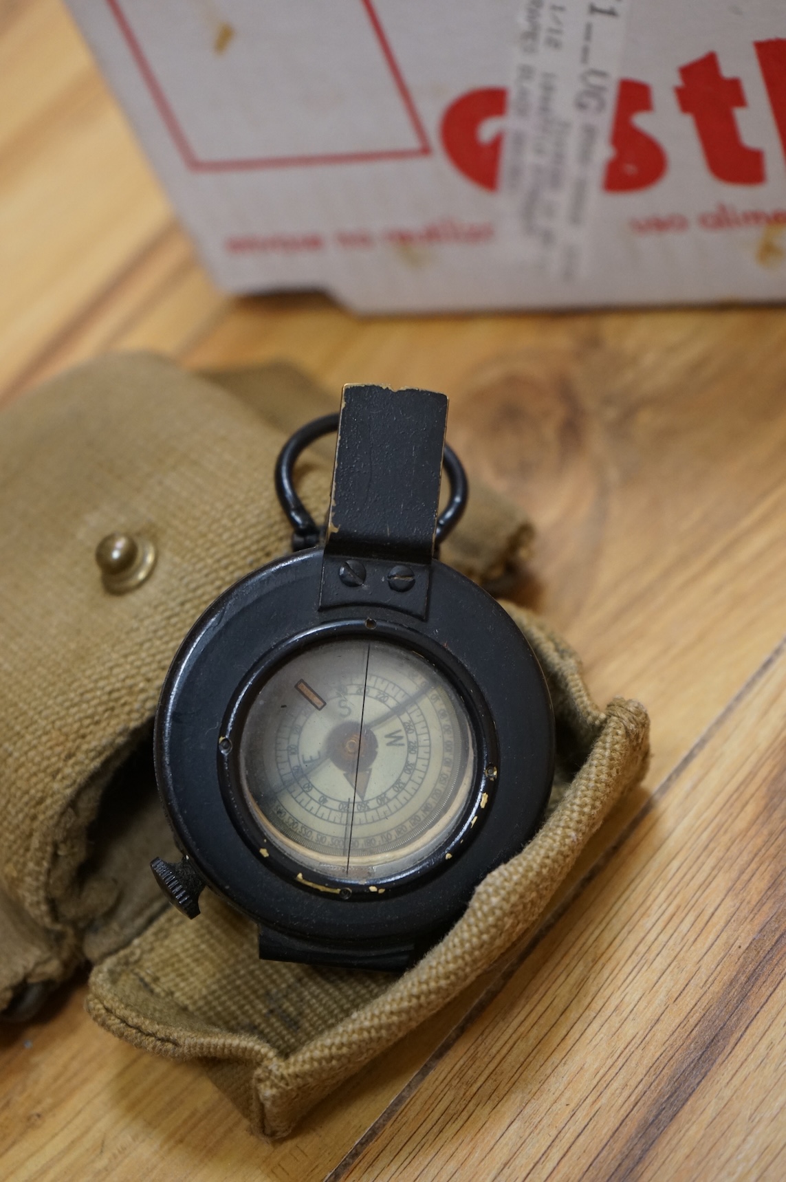 A Sykes-Fairburn Fighting Knife by Wilkinson sword in its leather scabbard, together with a 1942 Mk.III military compass by T.G.Co.Ltd. in a webbing pouch dated 1940, together with another compass, a telescope in a leath